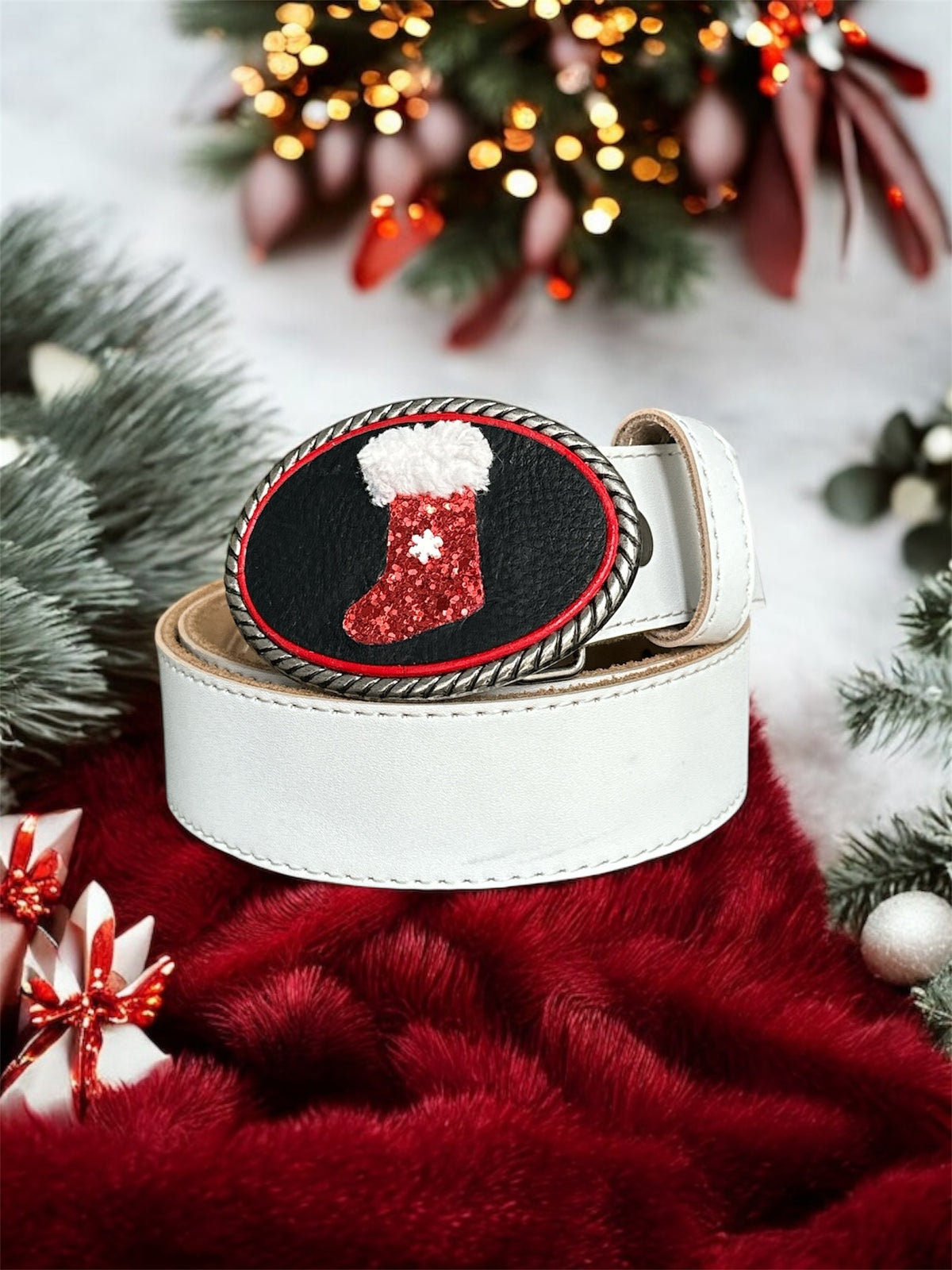 White belt with a red and black buckle featuring a Christmas stocking design, surrounded by festive decorations.