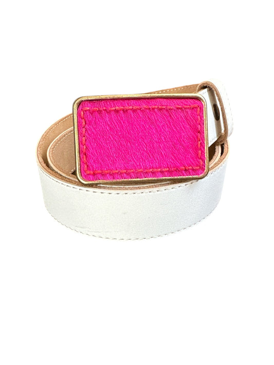 A rectangular belt buckle with hot pink hair on leather, set in a brass or silver buckle.