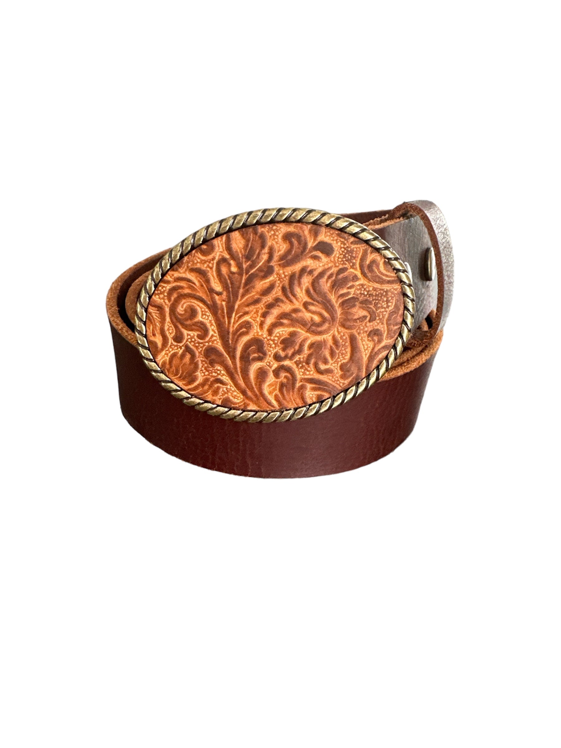 A brown leather belt buckle with embossed floral pattern and an antique brass rope.