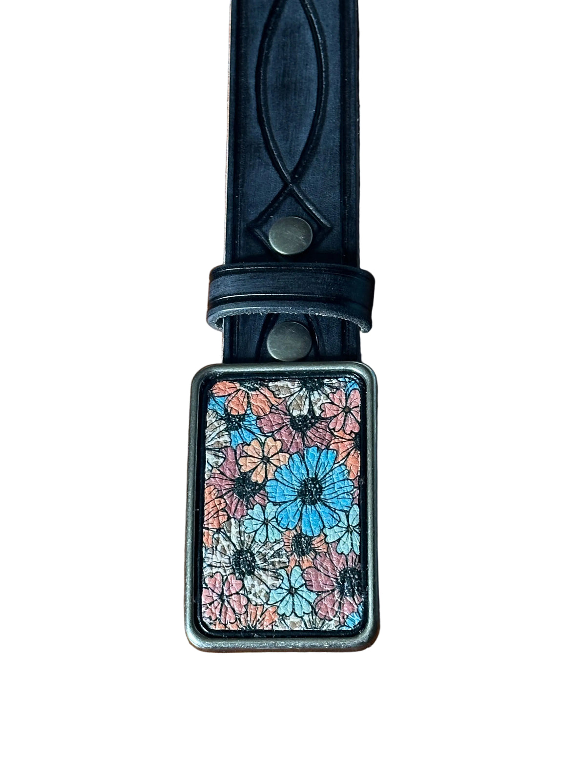 A black leather belt with a rectangular metal buckle featuring a colorful floral pattern in blue, pink, and orange, resting on a white background.
