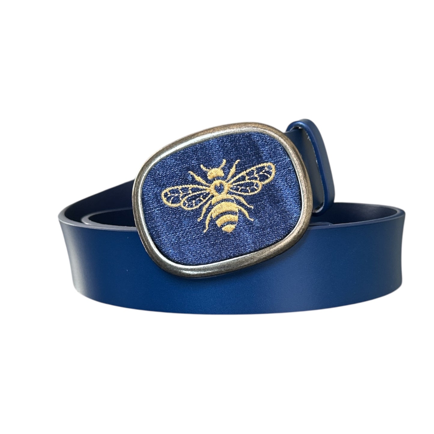 A bumble bee embroidered on blue jean set in an antique brass belt buckle with a blue belt 