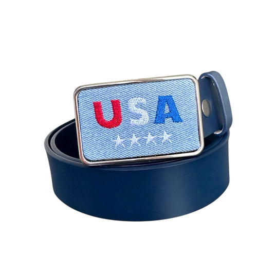 Rectangular embroidered denim belt buckle displaying 'USA' on a white background