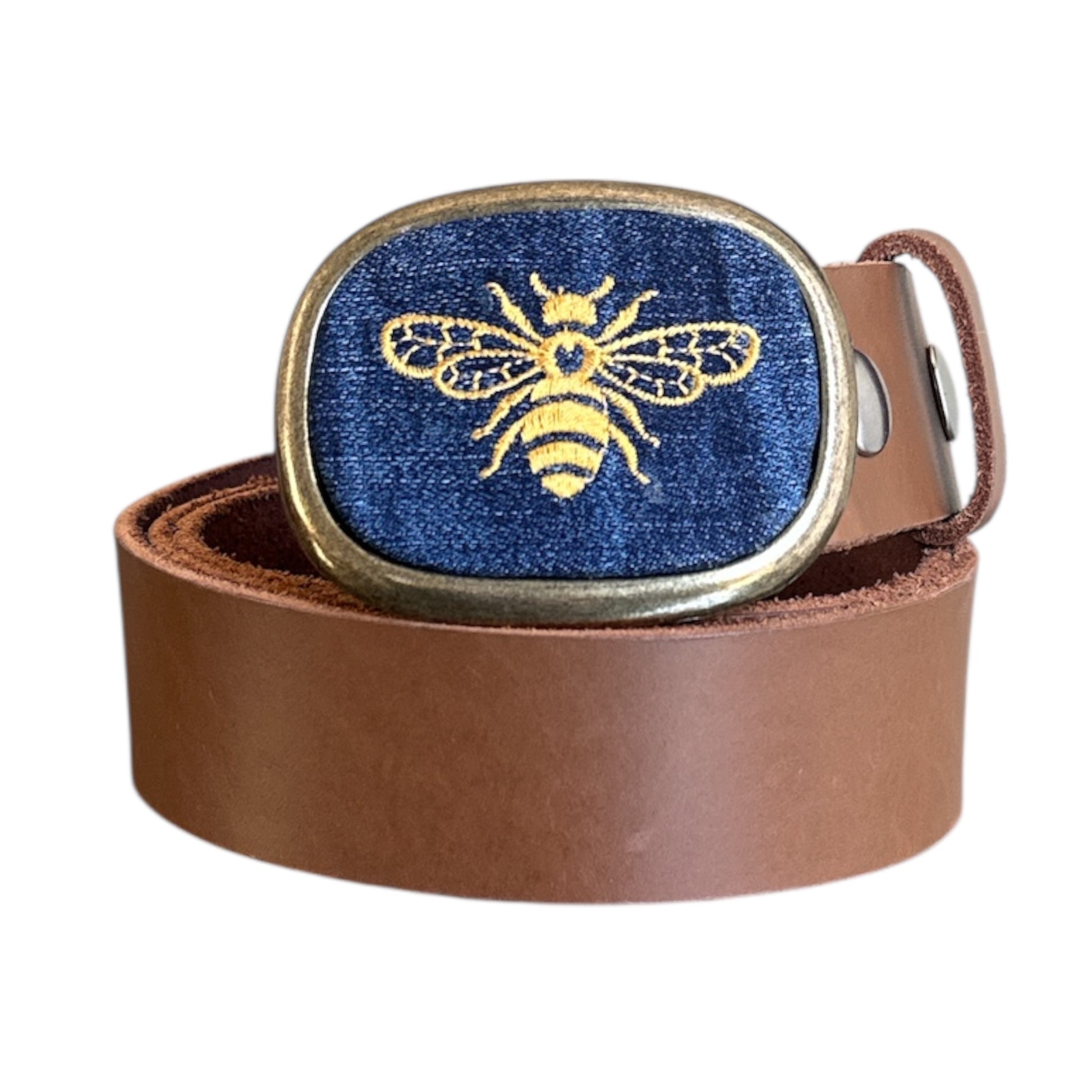 Brown leather belt with a gold and blue bee buckle on a white background