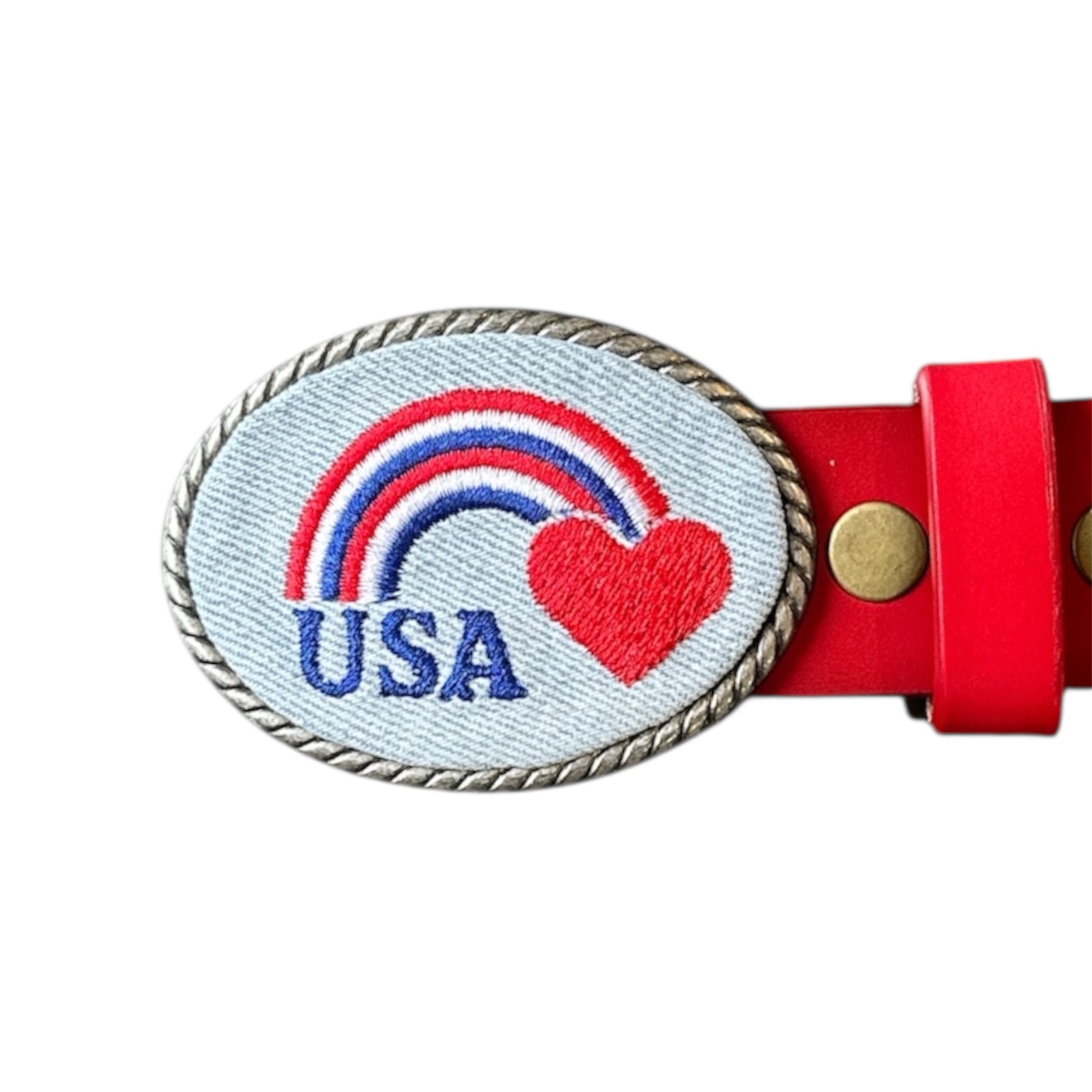 Belt buckle with rainbow on white denim on a white background