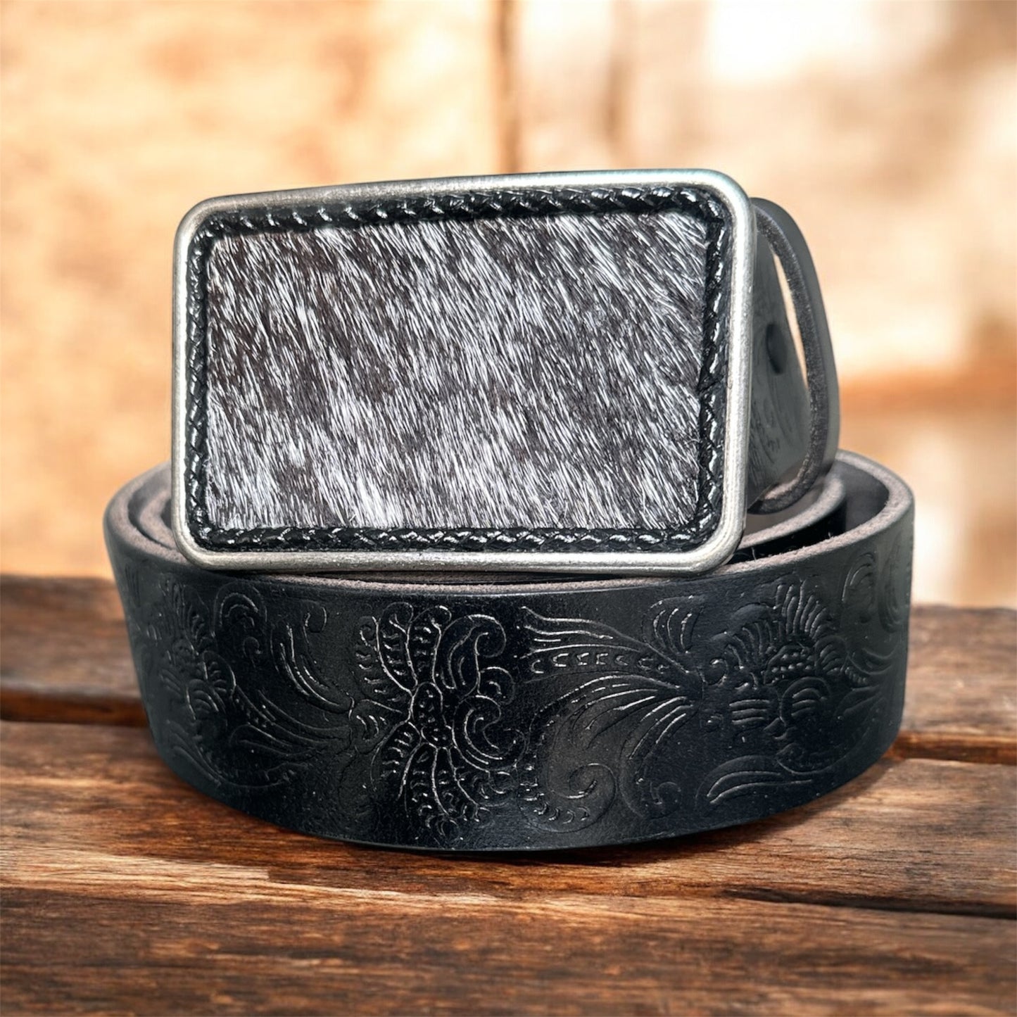 Silver belt buckle with hair on hide leather.