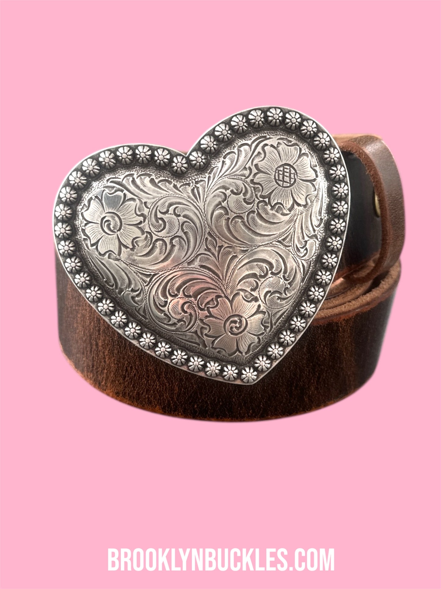 Heart-shaped silver buckle on a pink background with 'Brooklyn Buckles' branding.